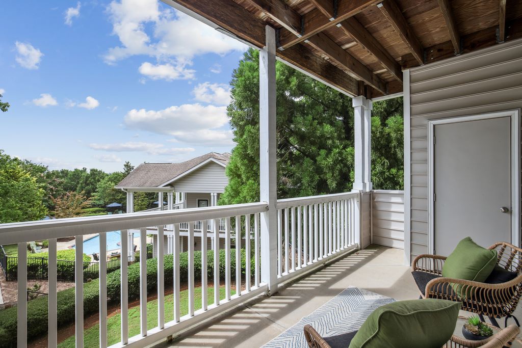 Staged balcony with storage overlooking the pool.